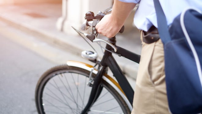 Close-up of man riding his bike in the street