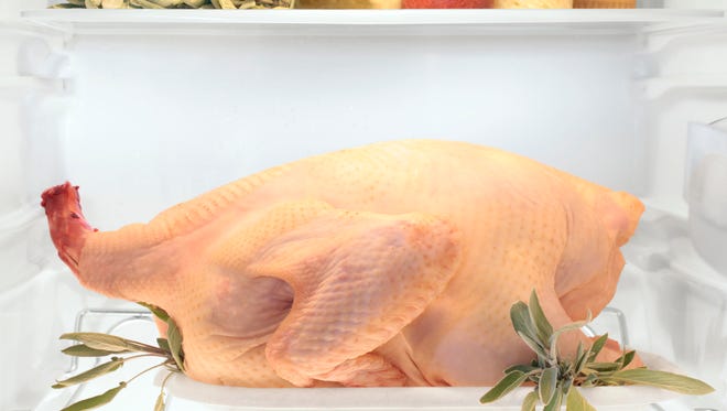 The USDA recommends thawing a frozen turkey in the refrigerator over several days.