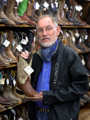 Sam Wald shows one of the brands carried at Tip Top Western Wear, 512 Garrison Ave, in downtown Fort Smith. Wald recently announced the store, a cornerstone business for downtown Fort Smith, was closing by the end of March.