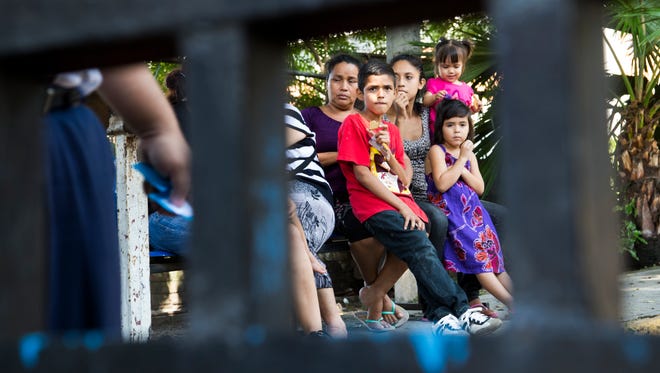 Families wait as loved ones are processed after being returned to El Salvador. Crime and a lack of jobs have sent Central Americans, including unaccompanied minors, to the U.S.