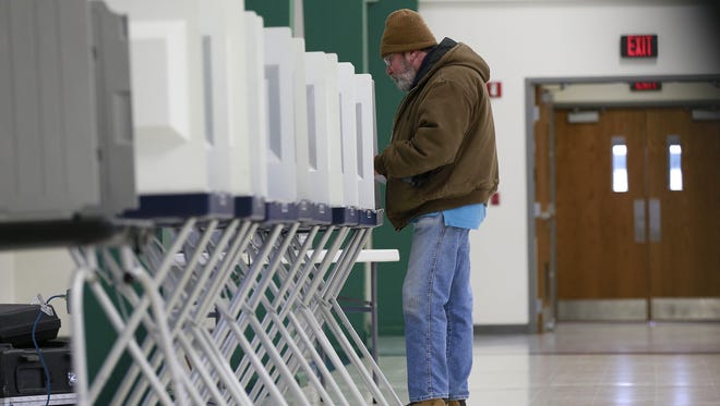 A person casts his vote on his ballot Tuesday, Feb. 20, 2018, at the Youth Building at Marathon Park in Wausau.