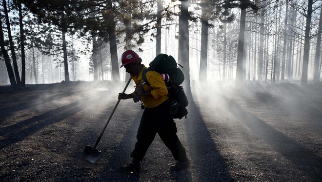A firefighter walks through the smoke of a burned forest near Boca Reservoir in August, 2014.