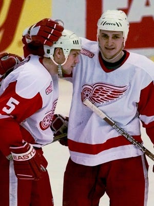Detroit Red Wings' Sergei Fedorov, right, congratulates Nicklas Lidstrom (5) after Lidstrom's goal Jan. 26, 2000.