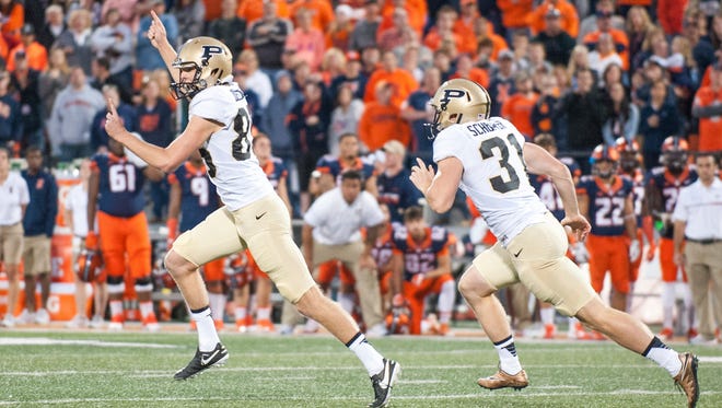 Purdue's J.D. Dellinger runs toward the sideline after kicking the winning field goal in overtime to beat Illinois.