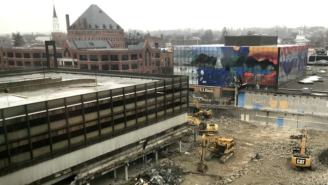 Crews with heavy equipment dismantle the former Burlington Town Center mall, including its adjacent parking lot, in this view from the southwest on Wednesday, April 25, 2018.