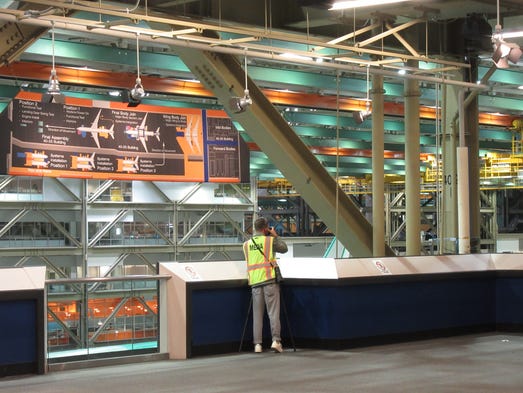 Media members take photos of Boeings assembly line