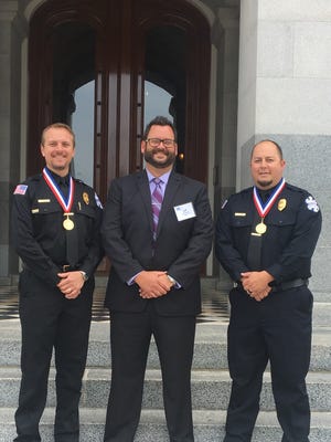 Ventura paramedic James Rosolek, from left, Jeff Winter, LifeLine director of operations, and Ventura paramedic Joey Williams stand on the steps of the Capitol in Sacramento for the Star of Life awards from the California Ambulance Association on April 30.