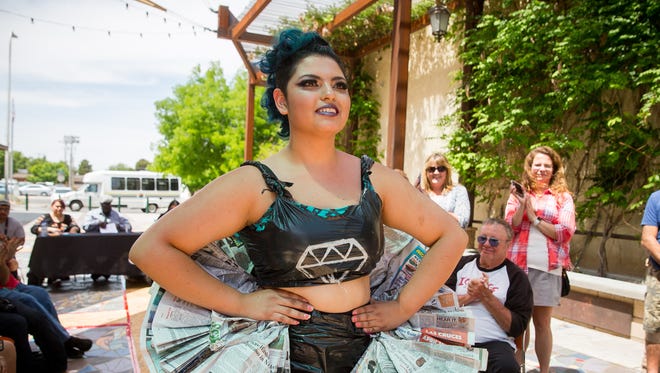Elaine Cuaron, dressed as a "punk rock ballerina" in an outfit made from recycled materials, struts a temporary catwalk in La Placita off of Main Street as part of Keep Las Cruces Beautiful's fourth annual Reuse & Recycle Fashion Show in honor of Earth Day.