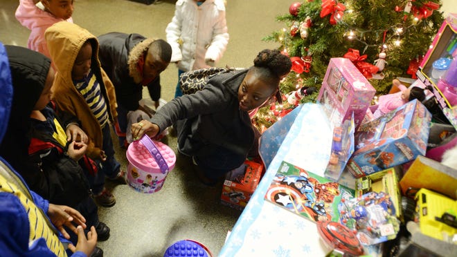 Families organize donations at Willie Kemp’s second annual toy drive for families in need Tuesday at the Hardeman County Courthouse. Kemp traveled all the way from Poland where he currently plays to help those in his community.