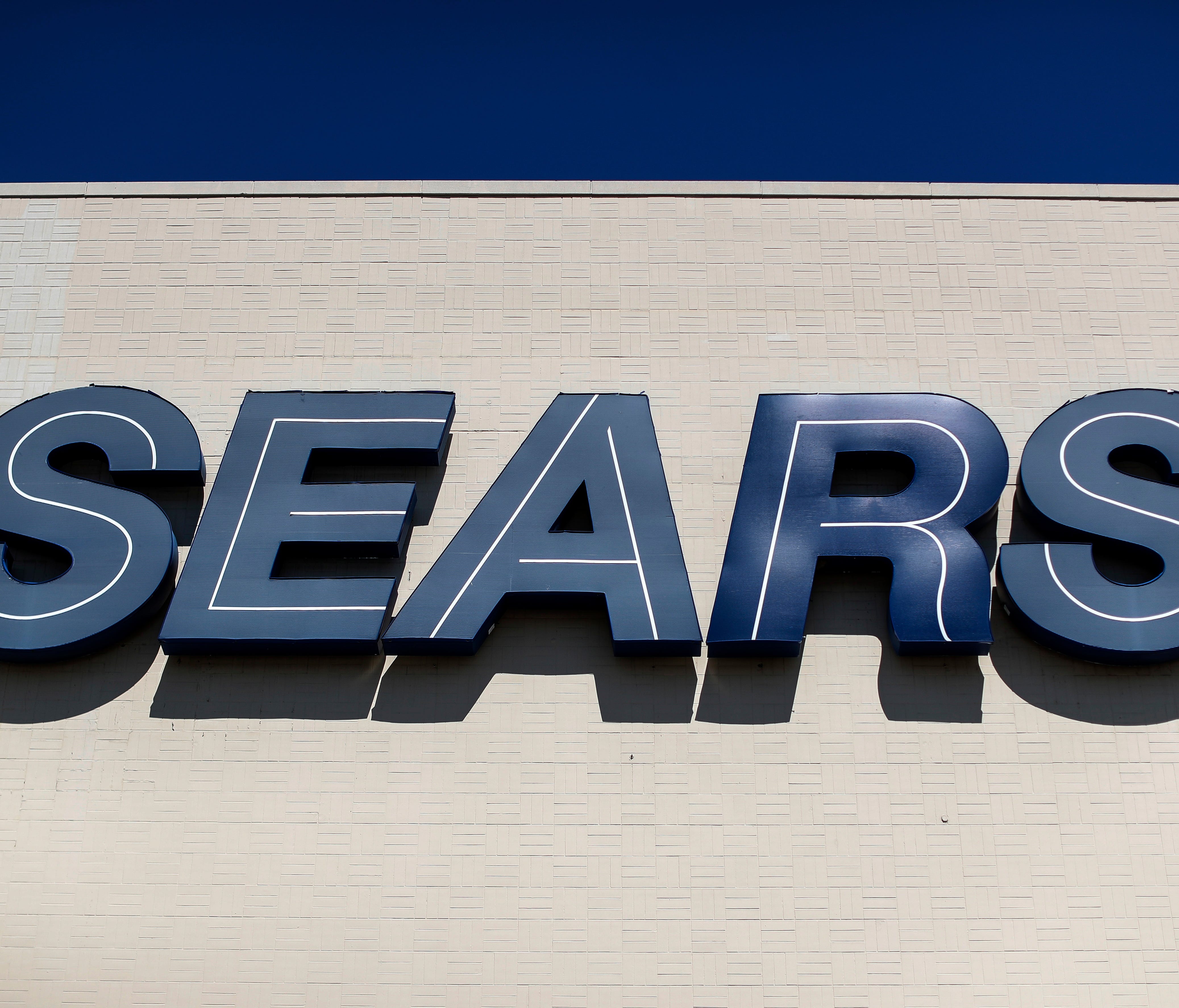 File photo taken in 2017 shows a Sears sign outside the retailer's department store at the Tri-County Mall, in Springdale, Ohio.