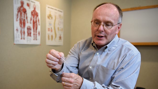 Jeff Varner describes the process he uses with acupuncture treatments with fertility patients Saturday, June 18, at Crossroads Chiropractic Clinic.