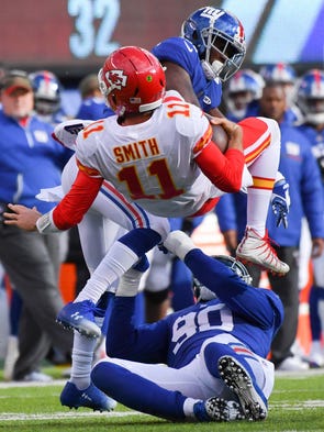 Kansas City Chiefs quarterback Alex Smith is up-ended