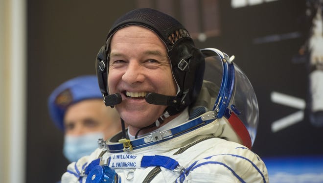 On March 4 at the Baikonur Cosmodrome in Kazakhstan, Expedition 47-48 crewmember Jeff Williams of NASA flashes a smile as he suits up in his Russian Sokol launch and entry suit during final pre-launch training. Williams and Alexey Ovchinin and Oleg Skripochka of Roscosmos will launch March 18 on the Soyuz TMA-20M spacecraft for a six-month mission on the International Space Station.