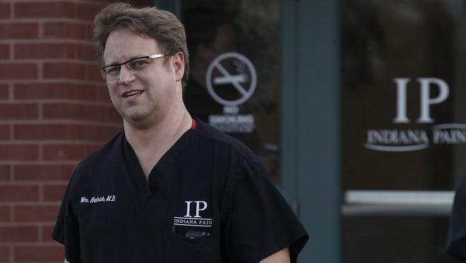 Physician William Hedrick walks out of his pain clinic at 3301 Fox Ridge Lane after members of the DEA, Attorney General's office and local agencies raided it in October 2014.