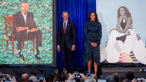 Former President Barack Obama and First Lady Michelle Obama stand beside their portraits after their unveiling at the Smithsonian's National Portrait Gallery in Washington on Feb. 12, 2018.