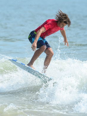 Mason Broussard, Gulf Shores, AL, catches a wave during the Men's Pro Division heat in the semifinals of the Skim USA Association ZAP Pro/Am Skimboarding Competition in Dewey Beach, De. on Friday, August 11, 2017.