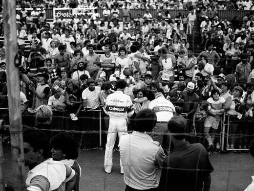 NASCAR driver Darrell Waltrip, center, greets fans