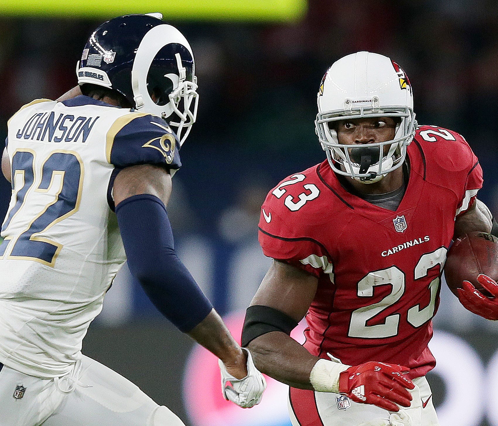 Arizona Cardinals running back Adrian Peterson (23) runs with the ball chased by Los Angeles Rams cornerback Trumaine Johnson (22) during the second half of an NFL football game at Twickenham Stadium in London, Sunday Oct. 22, 2017. (AP Photo/Tim Ire