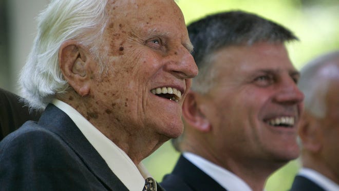 The Rev. Billy Graham, left, and his son, the Rev. Franklin Graham,  smile during a groundbreaking ceremony for the Billy Graham Library in Charlotte, N.C., Friday, Aug. 26, 2005.