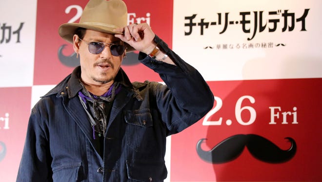 Johnny Depp poses for photographers during a photo session prior to a press conference to promote his latest film "Mortdecai" in Tokyo, Wednesday, Jan. 28, 2015.