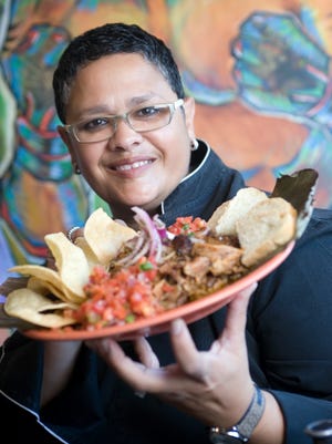 Chef Silvana Salcido Esparza of Barrio Cafe with her famed roasted pork dish, cochinita pibil. Photographed in 2014.