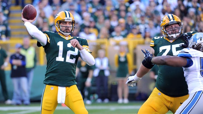 Green Bay Packers quarterback Aaron Rodgers (12) throws against the Detroit Lions at Lambeau FIeld.