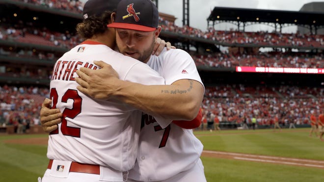 St. Louis Cardinals' Matt Holliday, right, hugs manager Mike Matheny following a 10-4 victory over the Pittsburgh Pirates in a baseball game, Sunday, Oct. 2, 2016, in St. Louis. The game will likely be the last for Holliday with the Cardinals. (AP Photo/Jeff Roberson)