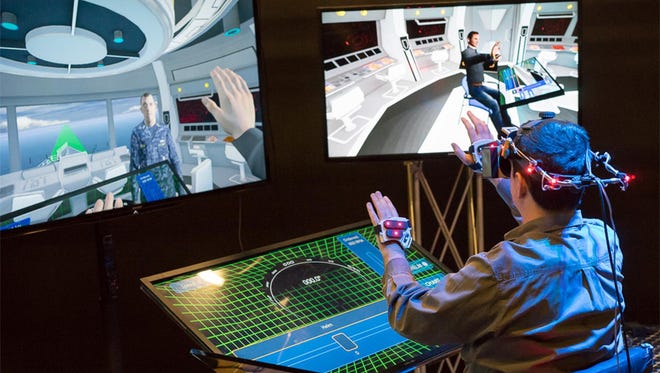 Caption: Ryan Spicer, a programmer at the University of Southern California's Mixed Reality Lab,  is put on-board a ships bridge using mixed reality technology. Credit: Todd Richmond