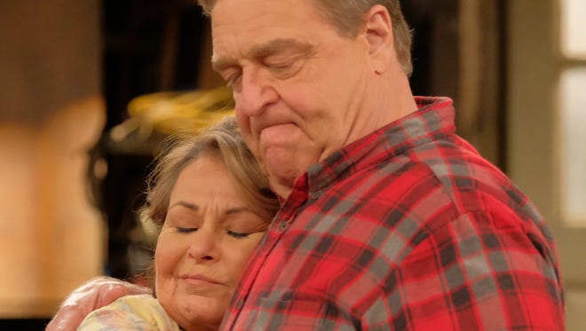 Roseanne (Roseanne Barr) and Dan (John Goodman) share a hug on ABC's 'Roseanne.'