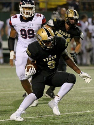Rider running back Willie Phillips attempts to out maneuver Dentons defense Friday night as the Raiders hosted the Denton Ryan Raiders at Memorial Stadium.