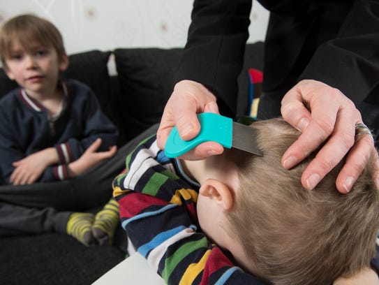 Parents doing a head check on their children should