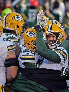 Mason Crosby (2) is surrounded by teammates after hitting a 32-yard field goal with 3 seconds left in the game to give the Green Bay Packers a 30-27 win over the Chicago Bears on Dec. 18, 2016.