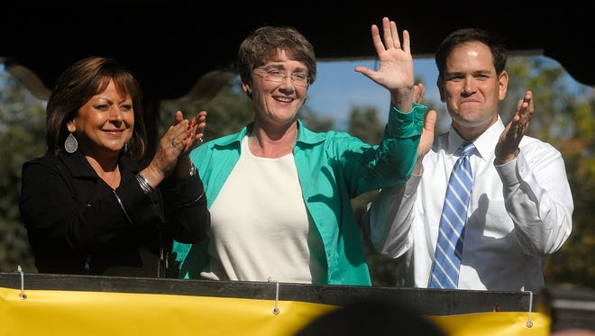 New Mexico Senate candidate Heather Wilson waves to a crowd of locals with New Mexico Gov. Susana Martinez and Flordia U.S. Sen. Marco Rubio Wednesday, Oct. 25, 2012. Martinez and Rubio were campaigning for Wilson. Martinez recently announced she is supporting Rubio in his presidential campaign.