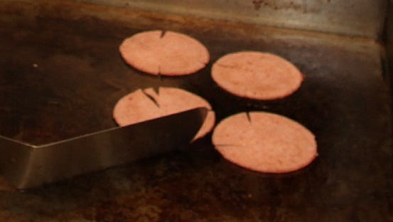Pork roll slices being on the griddle. Case Pork Roll Co. has been accused of firing an employee who passed too much gas.