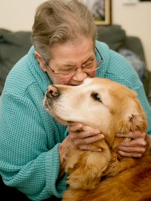 Bonita Swan hugs her assistance dog, Ann at her home in Stevens Point, Monday, Oct. 5, 2015.