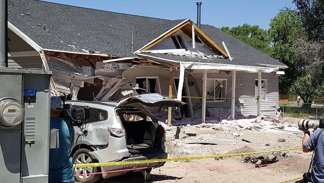 This July 14, 2016 photo provided by Dennis Sanders shows a house in Panaca, Nev. after it was destroyed by explosives. Arizona police announced Friday the discovery of improvised bombs and several pounds of explosives found in Kingman, Ariz., in the home and car of a man who traveled to the quiet Nevada town and set off bombs that killed him and showered the community with shrapnel and debris. (Dennis Sanders via AP)