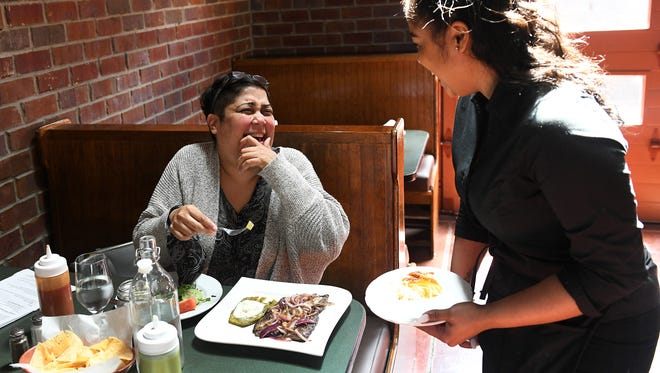 Patron Maria Aloyo of Allen Park chats with server Heylee Canales after lunch is served at La Noria Bistro.