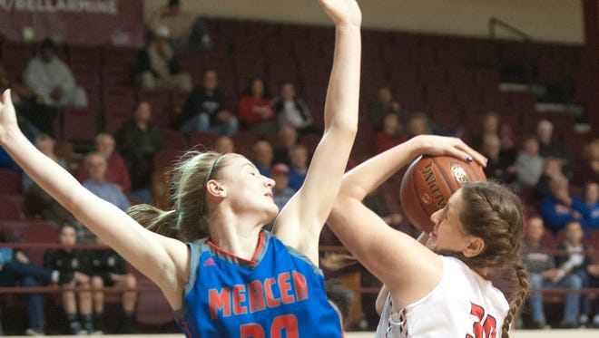 Mercer County center-forward Emma Souder defends the basket as Butler center Molly Lockhart tries to put up a shot.Jan. 26, 2018