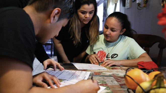 Claudia Bahena, 21, of Burlington, N.C., right,  registers to vote during a voter registration drive by community activists in Burlington, N.C., on March 11.