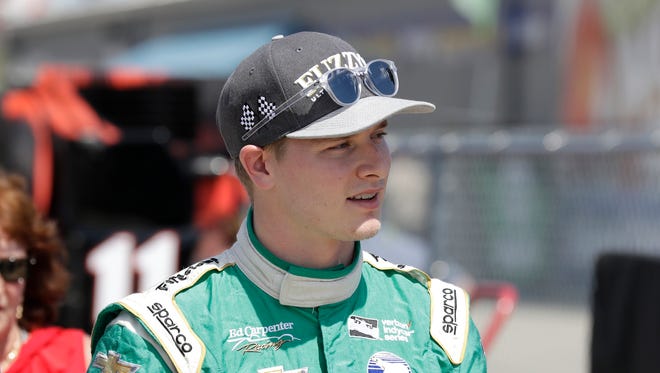 FILE -- Josef Newgarden walks back to the garage ares following practice for the IndyCar Series auto race Saturday, July 9, 2016, at Iowa Speedway in Newton, Iowa. (AP Photo/Charlie Neibergall)