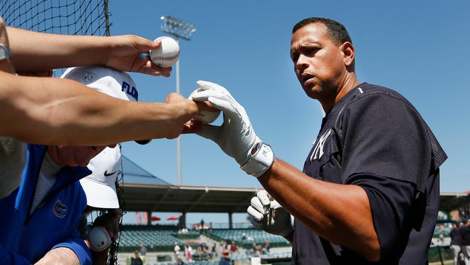 Yankees third baseman Alex Rodriguez signs autographs for fans before a spring training game. Rodriguez has been a positive force at Yankees’ spring training this year.