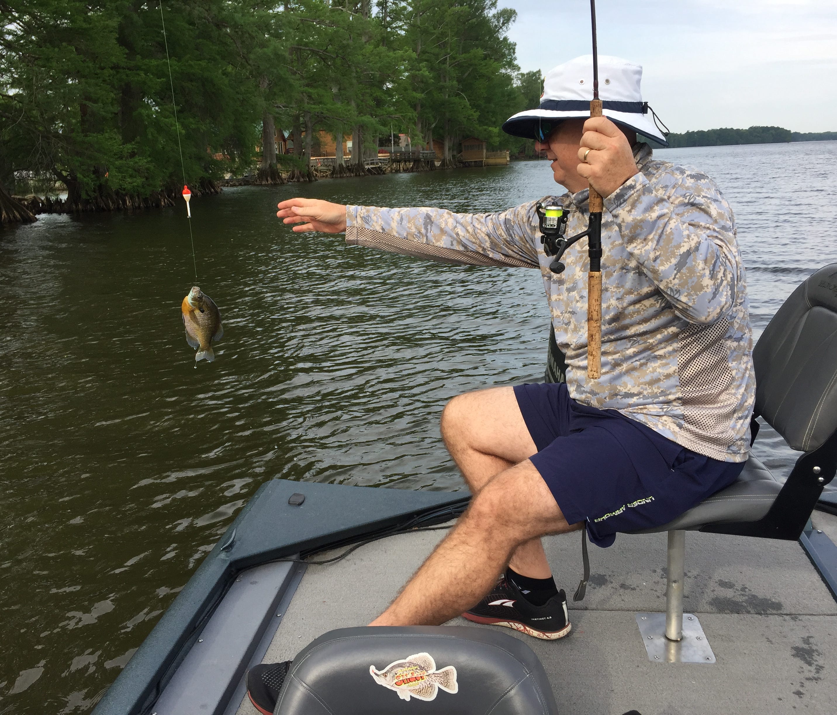 Alan Clemons brings a bluegill to hand. He learned to located spawning beds by smell when fishing as a child with his mother and father, Ann and Charles Clemons. 