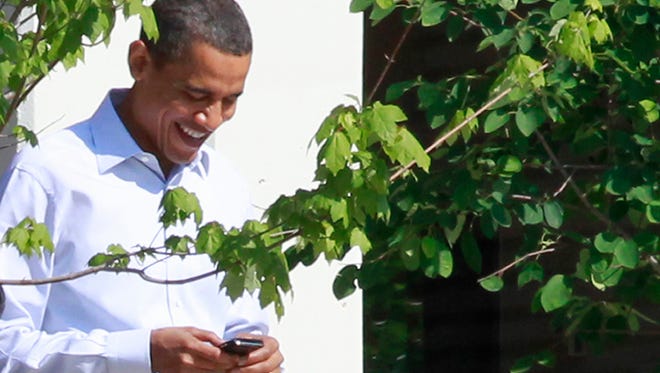 President Obama uses his BlackBerry phone.