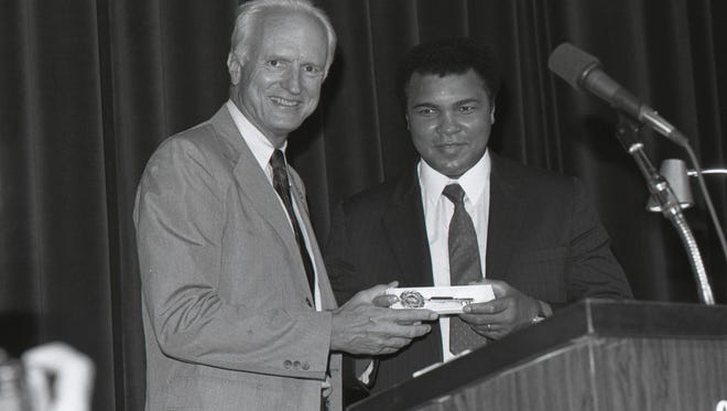 Mayor Hudnut presents a key to the city to Muhammad Ali at an Indiana Black Expo lunch at the Indiana Convention Center on July 17, 1987.