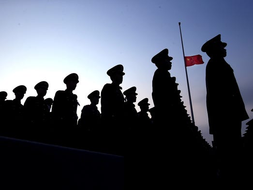 Chinese paramilitary policemen stand at attention near