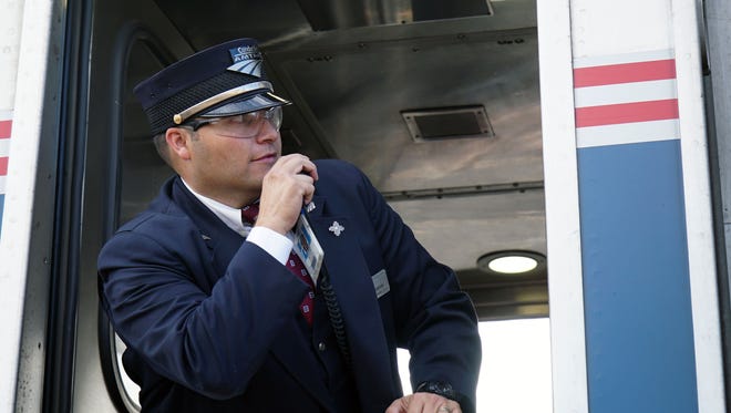 Amtrak conductor Esteban Montoya Jr. radios the all-clear for the Southwest Chief service to leave Raton, N.M.