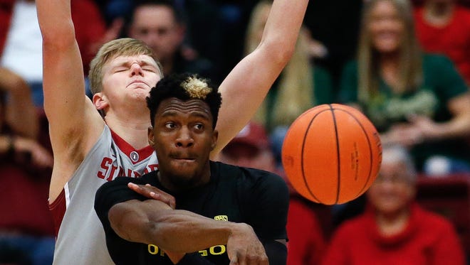 Oregon Ducks guard Dylan Ennis (31) passes the ball against Stanford Cardinal forward Michael Humphrey (10) during the first half of the game at Maples Pavilion.