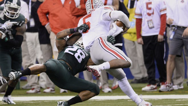 MSU's Denicos Allen makes a fourth-down stop of Ohio State quarterback Braxton Miller late in MSU's  Big Ten Championship game win in December of 2013. It is one of the critical moments in MSU football history.