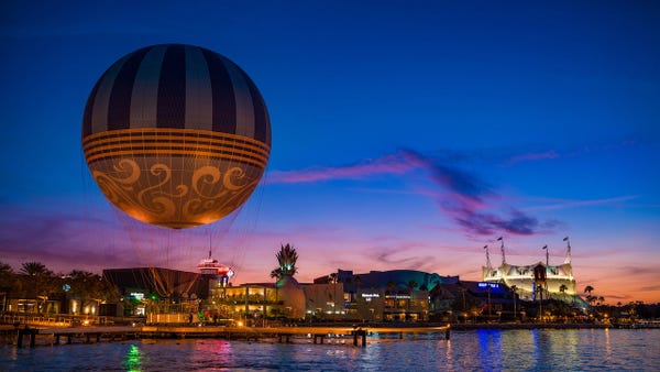 Panoramic view of Disney Springs across the lake a