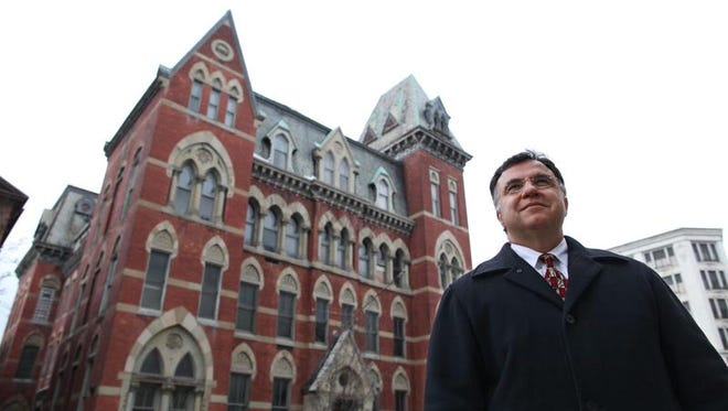 George Traikos of the Traikos Real Estate Group stands in front of the Academy Building, 13 S. Fitzhugh St., in 2010.